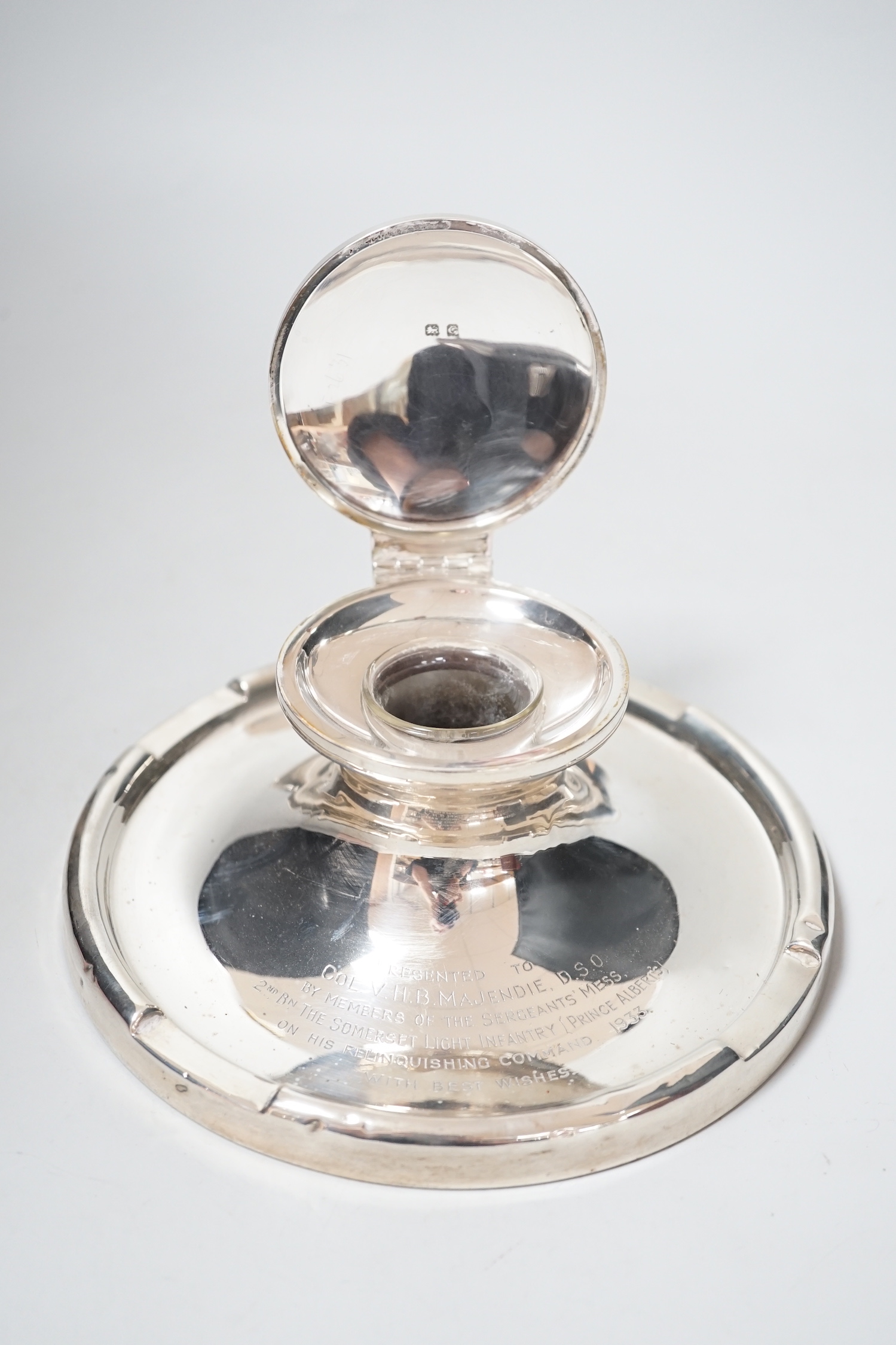 A George V silver mounted capstan inkwell, with Light Infantry related inscription, A & J Zimmerman, Birmingham, 1931, diameter 17.7cm.